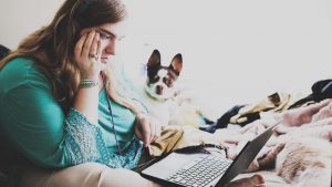 Young woman with autism and other learning disabilities using laptop for remote learning